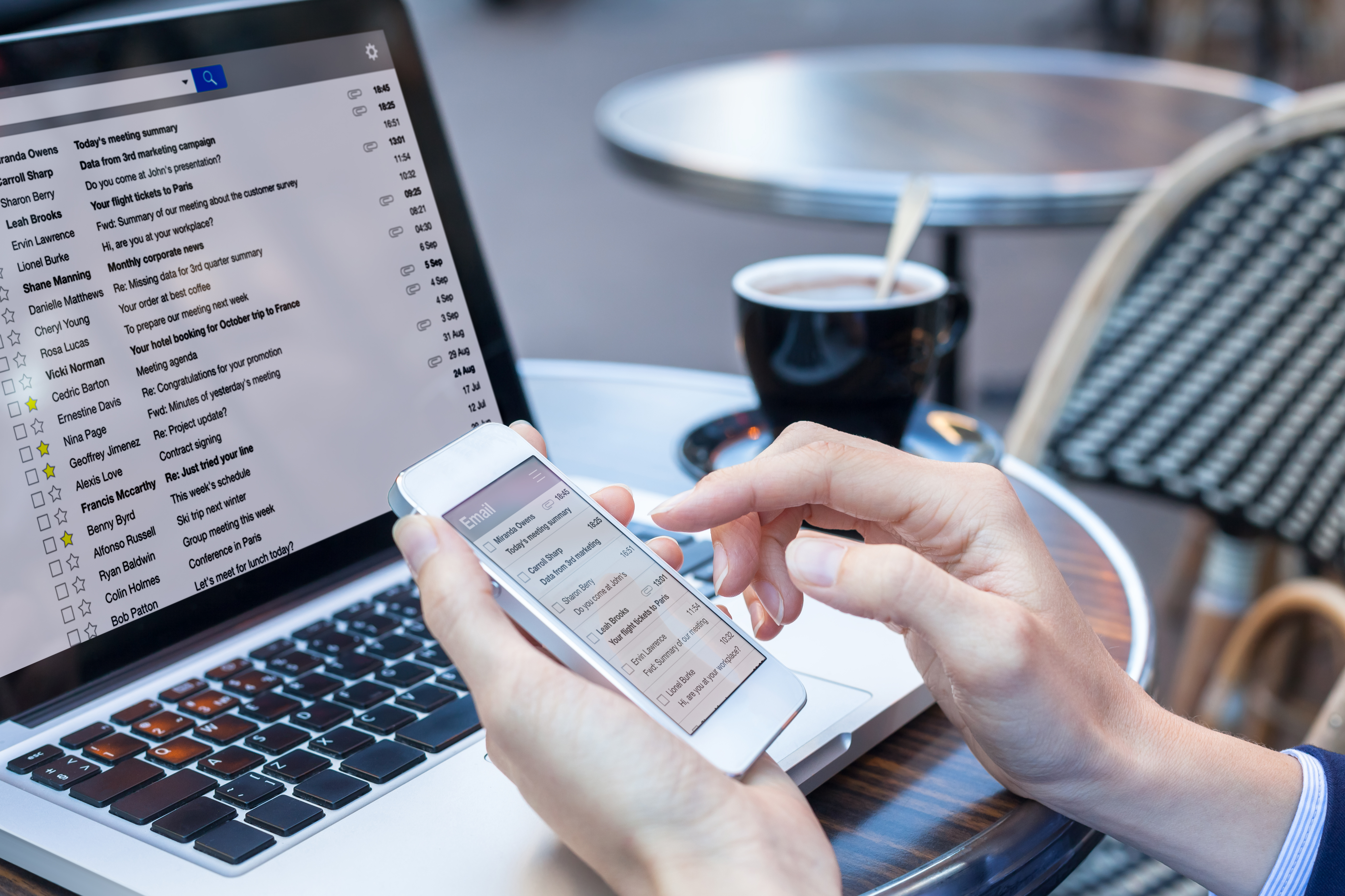 Laptop and smartphone showing lots of emails